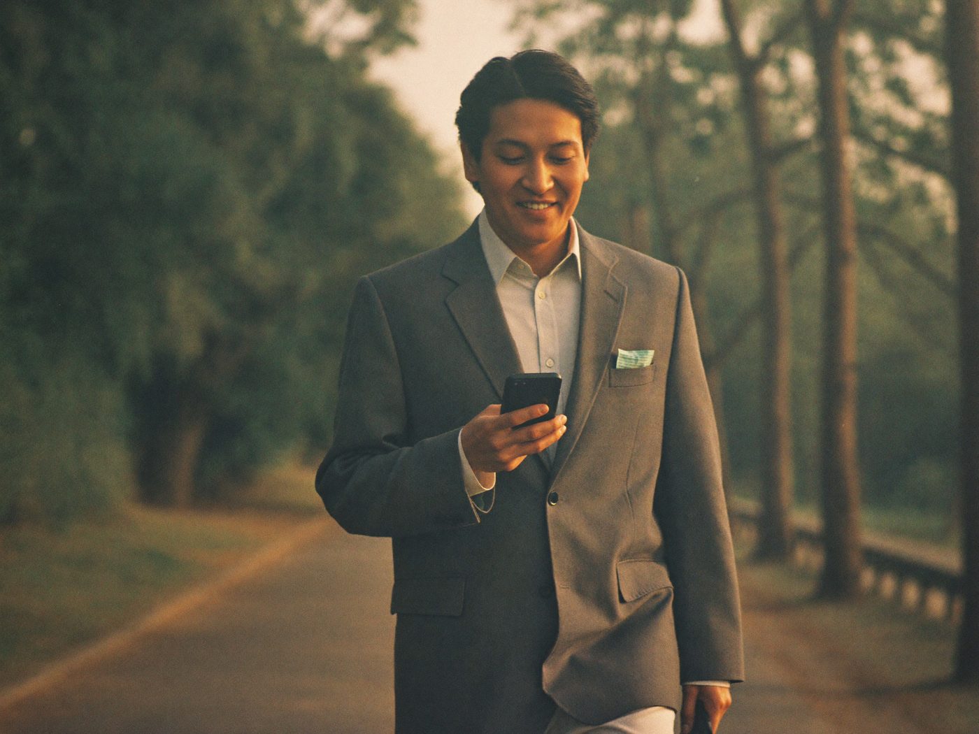 Business owner walking outside, glancing at a phone while automations handle the work